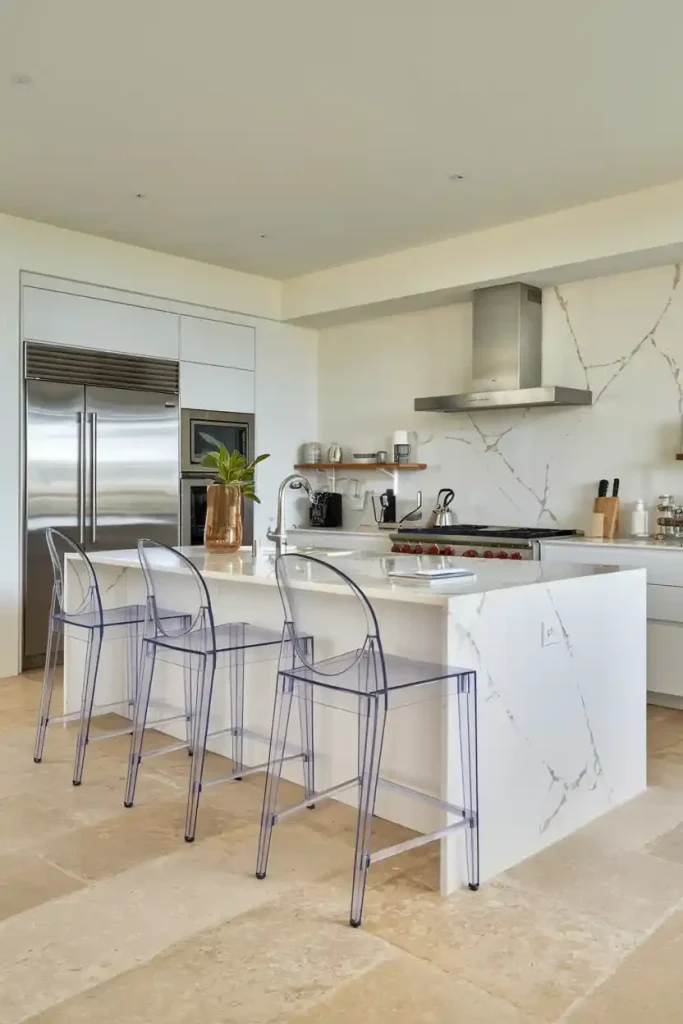 Minimalist acrylic ghost stools arranged around a white marble kitchen island, creating an illusion of spaciousness in a contemporary kitchen" "Industrial-style metal and reclaimed wood bar stools with footrests, paired with a concrete-top kitchen island in a loft-like setting