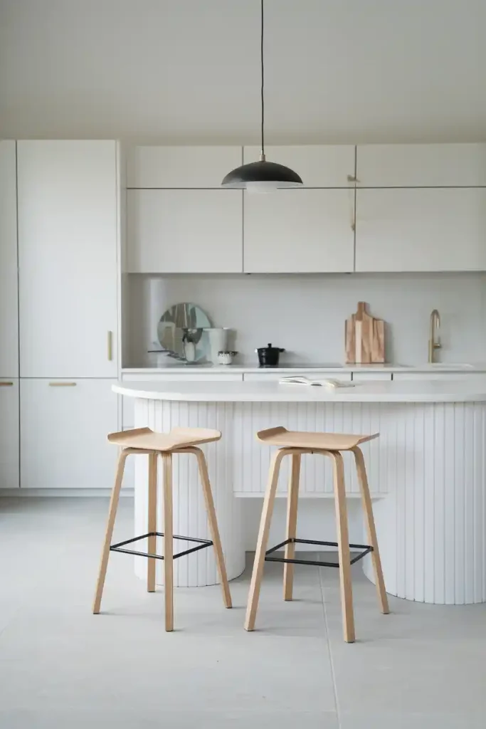 the Normann Copenhagen Form Bar Stool with a modern, Scandinavian minimalist kitchen featuring light colors and clean lines. Show both versions: with and without a backrest for variety.