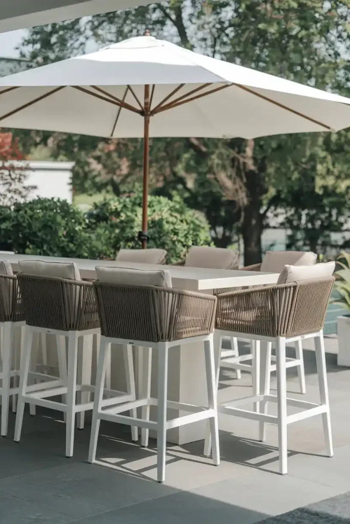 Outdoor Patio Bar Stools: Stylish outdoor bar stools made of weather-resistant materials, arranged around a patio table with greenery in the background.