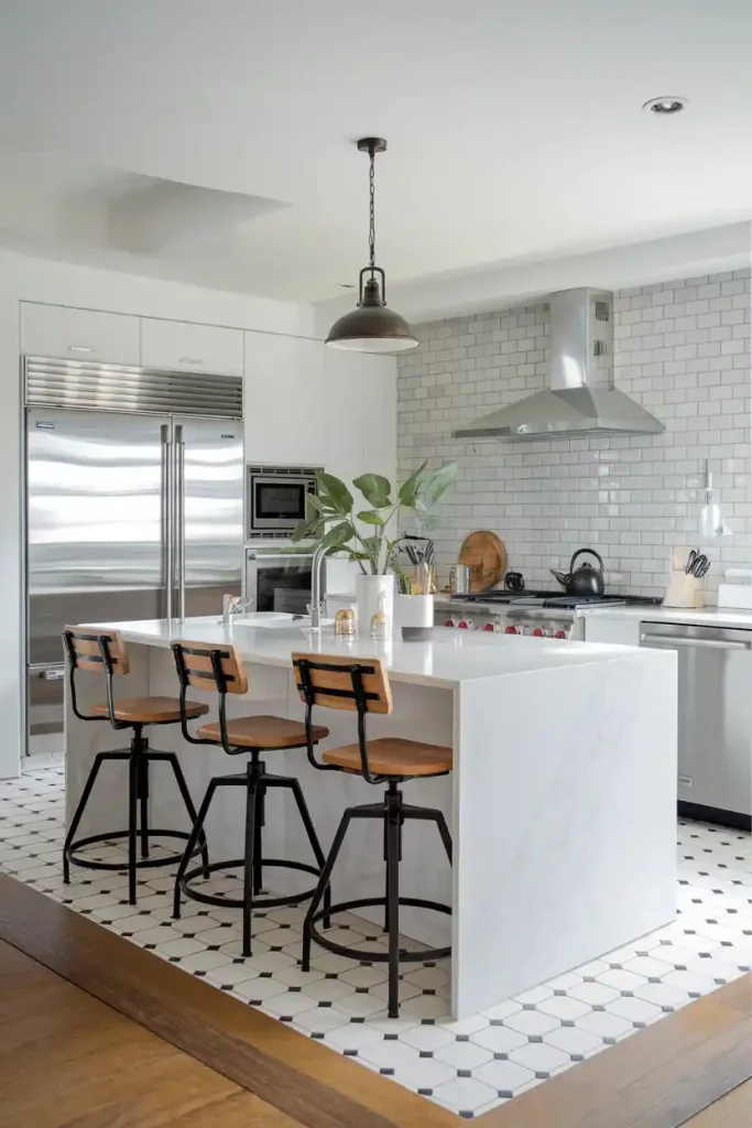 A sleek, modern kitchen with a white marble island featuring three black metal and wood industrial-style bar stools.