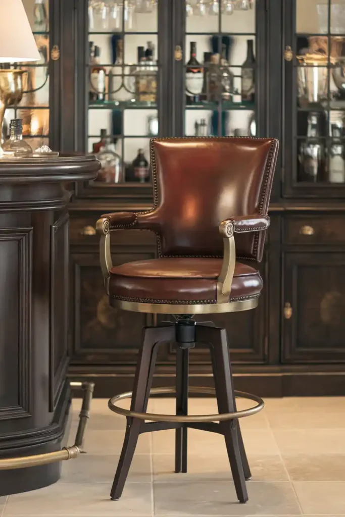 Classic Leather Bar Stool: Depict an elegant 36-inch bar stool with a rich brown leather seat and brass accents, positioned at a sophisticated home bar with dark wood cabinetry.