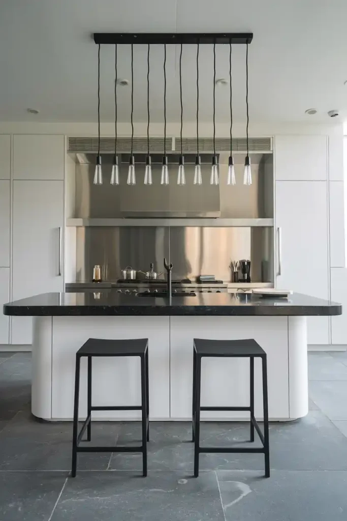 a minimalist Scandinavian-style kitchen island featuring light wood accents and a set of sleek, white bar stools with natural wood legs.