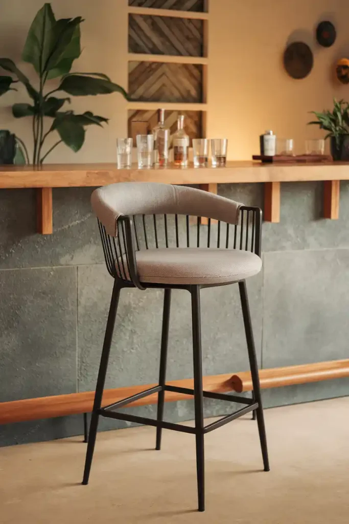 Modern Minimalist Bar Stool: Create an image of a sleek, modern 36-inch bar stool with a black metal frame and a cushioned seat in a light gray fabric, set against a contemporary home bar backdrop.