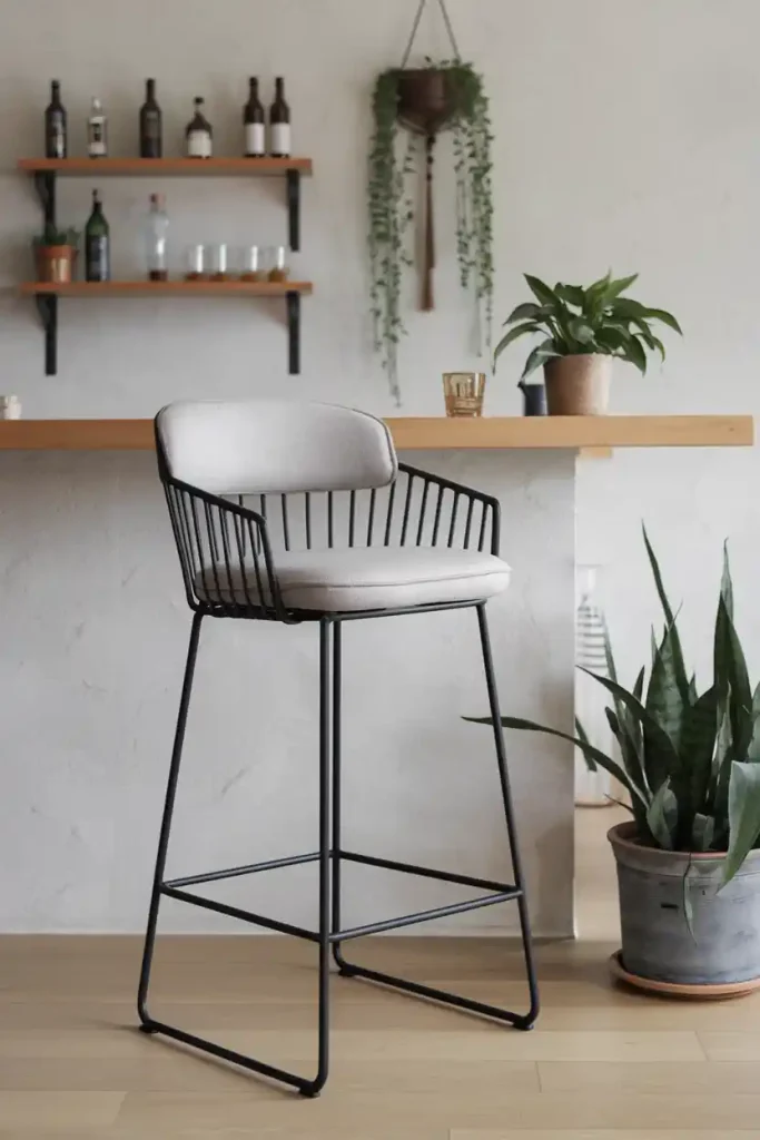 Modern Minimalist Bar Stool: Create an image of a sleek, modern 36-inch bar stool with a black metal frame and a cushioned seat in a light gray fabric, set against a contemporary home bar backdrop.