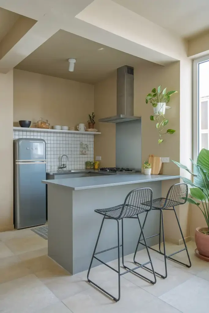 Compact Kitchen Space: A small yet functional kitchen with a grey island and space-saving bar stools, demonstrating clever design for limited areas.