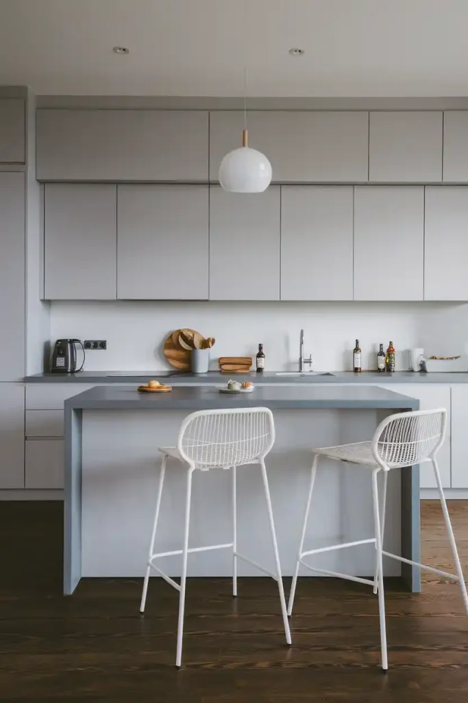 Modern Grey Kitchen Island: A sleek, contemporary kitchen featuring a grey island with stylish bar stools, showcasing a minimalist design.