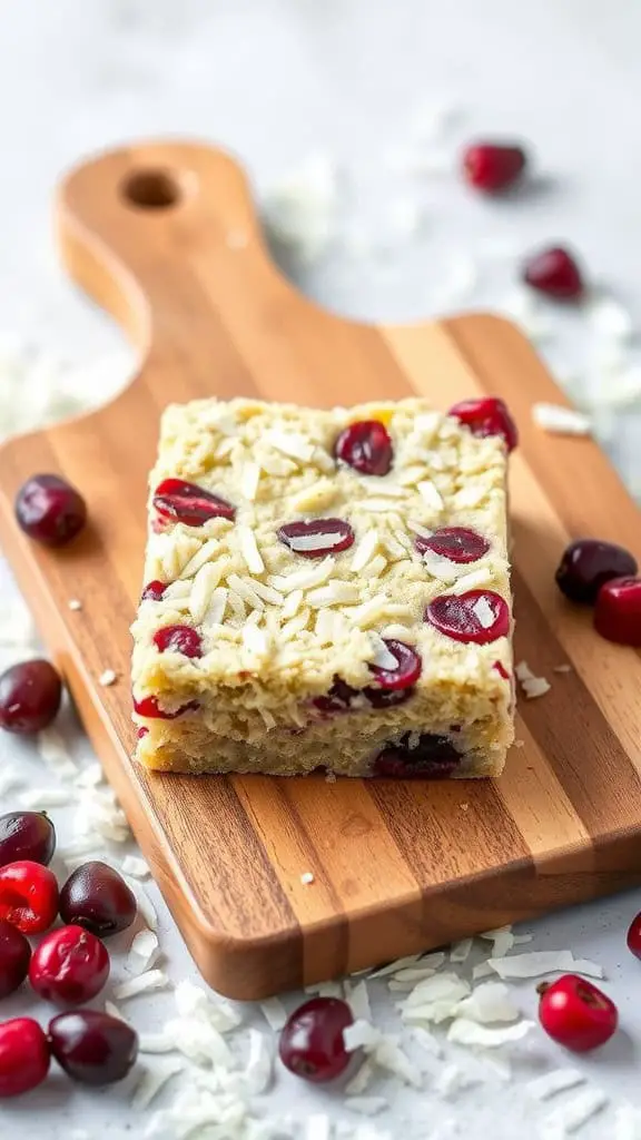 Cranberry Coconut Bars on a wooden cutting board with fresh cranberries scattered around.